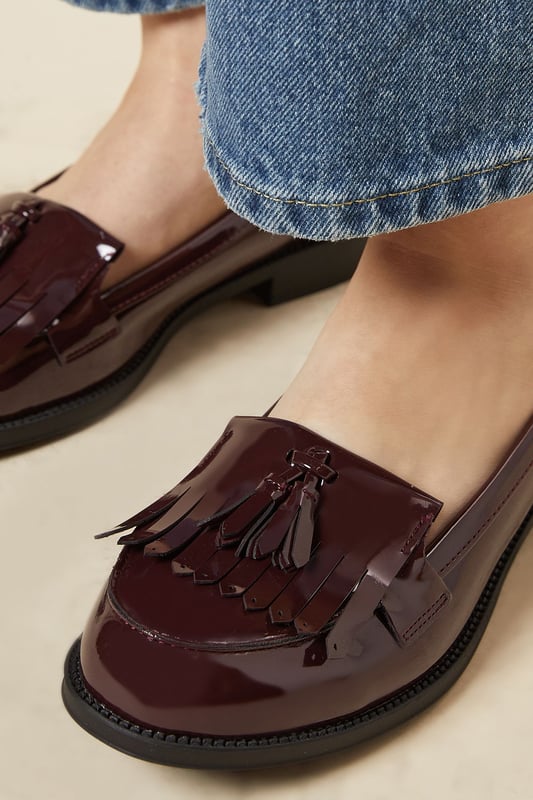Faux leather loafers with a wide fit for added comfort
Sleek and polished design with a fringed tassel detail
Flat sole offers a versatile wear from day to night
Slip-on style for easy on and off
Synthetic lining and outsole for durability

Exude effortless sophistication with these Wide Fit Leigh Fringe Loafers from Dorothy Perkins. The faux leather construction lends a luxurious touch, while the fringed tassel detail adds a playful twist to the classic silhouette. Designed with a wide fit, these loafers offer ample room for all-day comfort. Pair them with tailored trousers for a polished office look or team them with a flowy dress for a chic weekend ensemble. Their flat sole ensures versatility, allowing you to transition seamlessly from desk to dinner.