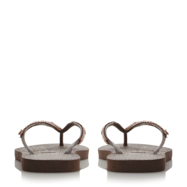Add some sparkle to your summer style with this metallic mesh flip flop. A classic toe post style with slim straps and miniature branded coin charm.