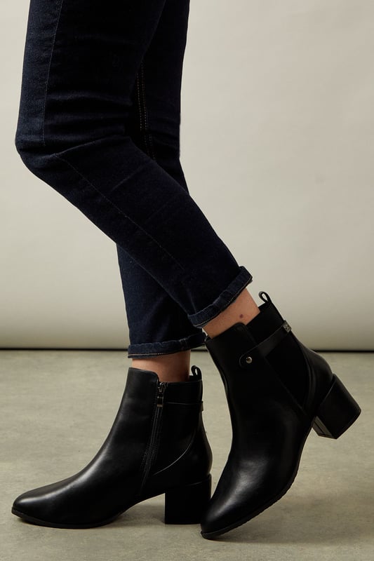 Wide fit design for enhanced comfort
        Elastic gusset for easy slip-on
        Medium block heel measuring between 5 and 6.5cm
        Sleek ankle-length silhouette
        Versatile day-to-night style
    
    Step out in style and comfort with these sophisticated Ahio ankle boots from Wallis. Crafted with a wide fit and featuring an elastic gusset, these boots offer both ease and elegance. The medium block heel, measuring between 5 and 6.5cm, provides a perfect balance of height and stability. Ideal for the woman who values both fashion and function, these boots transition seamlessly from day to night. Pair them with tailored trousers and a crisp blouse for a polished office look, or style them with a flowing midi dress for an evening out. The versatile design makes these boots a wardrobe essential, suitable for various occasions from casual outings to more formal events. With their timeless appeal and practical features, these Wallis boots are set to become your go-to footwear for any season.