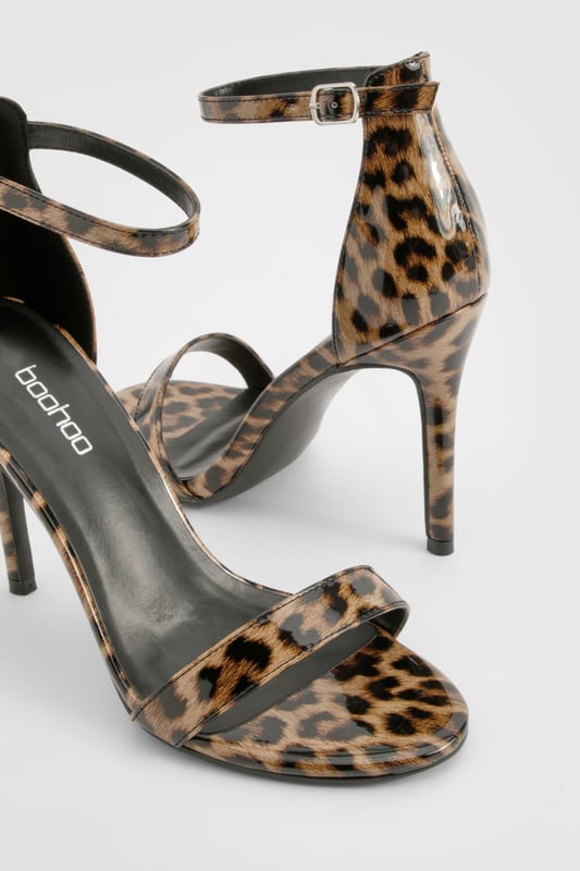 Striking leopard print design for a bold statement
        Sleek ankle strap with adjustable buckle fastening
        Elegant high heel measuring between 7 and 9cm
        Minimalist single strap across the toes for a modern look
        Versatile silhouette suitable for various outfits and occasions
    
    Make a fierce impression with these eye-catching leopard print heels from Boohoo. Perfect for the fashion-forward woman who loves to stand out, these shoes combine classic style with a wild twist. The slim ankle strap provides secure support, while the single strap across the toes keeps the design sleek and contemporary. Ideal for a night out on the town, these heels will effortlessly take you from dinner to the dance floor. Style them with a little black dress for a timeless look, or pair them with tailored trousers and a silk blouse for a more sophisticated ensemble. Whether you're heading to a cocktail party or a girls' night out, these versatile heels will ensure you're always dressed to impress.