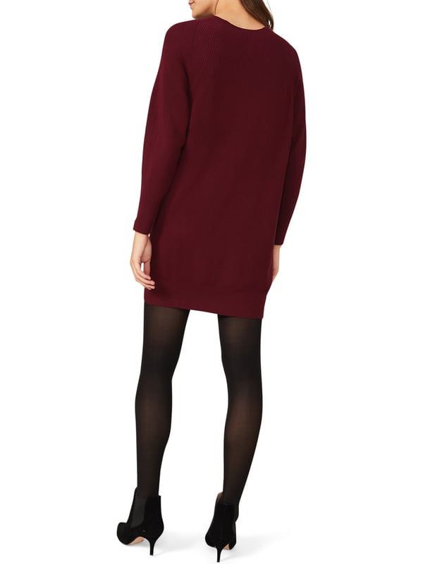 An effortless knitted tunic dress designed in an autumnal shade of port. Featuring a high neckline long sleeves and relaxed silhouette this flattering style looks great with skinny jeans and boots.