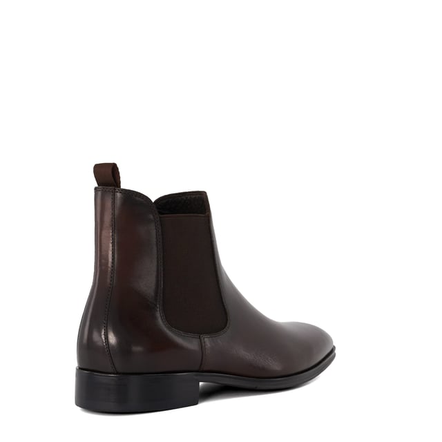 Dune Mens MANDATORY Chelsea Boots Mandatory Synonymous with Dune London, the Chelsea boot is a long-standing classic favoured for its transitional appeal. Signature style Mandatory perfectly blends a contemporary aesthetic with our iconic heritage. Crafted from the finest material and detailed with a quintessential elastic side gusset and grosgrain pull tab, this almond-toed silhouette has been set on a durable rubber outsole. Finished with tonal stitching, this timeless style will become a go-to dressing solution throughout the season.