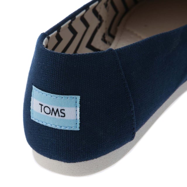 Womens Toms Recycled Cotton Canvas Alpargata Espadrille Pumps in navy.- Recycled cotton upper  lining and sock-liner made with 50% recycled cotton.- Classic Alpargata design.- Toe-stitch and elastic V for easy on and off.- Chevron patterned canvas lining.- Custom insoles made with 50% eco content including recycled PU foam.- Direct injection outsole for flexibility and durability with tread pattern for improved traction.- Toms branding to side and back of heel.- 100% vegan construction.- Textile upper  Textile lining  Synthetic and textile sole.- Ref:10017712