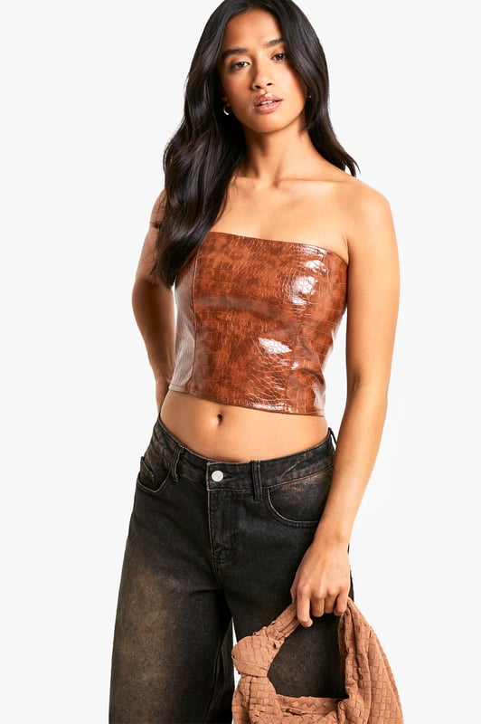 Petite Croc Look Faux Leather Bandeau Corset Top Gain some serious style points this season in this petite top. Cut shorter to ensure the perfect fit, our tops for petite women are designed for queens 5'3'' and below. From petite t-shirts to petite blouses, we've got all the new-season styles you need in your wardrobe. Feeling casual? Dress it down with a pair of straight leg jeans and chunky trainers. If out out is more your vibe, team with some distressed hem shorts and killer heels for a major style statement. Style: CorsetFabric: PUNeckline: Bandeau