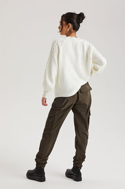 Model is 5'6 and wears a size S.Pockets. Drawstring waist band. Cuff hem. Introducing our Khaki Parachute Cargo Trouser, a versatile and stylish addition to your wardrobe that effortlessly combines functionality with fashion-forward design. Crafted with attention to detail and quality, this cargo is perfect for those who seek comfort without compromising on style.