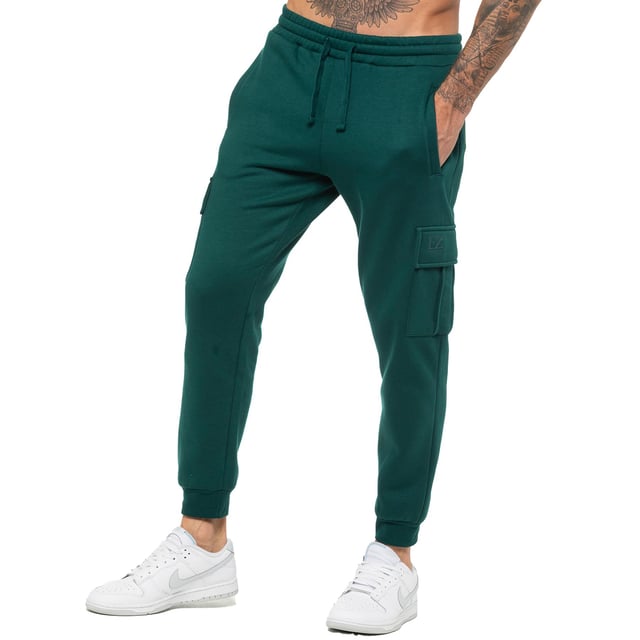 Enzo Mens Regular Fit Cargo Joggers. Features 2 Side Slash Pockets, 2 Cargo Pockets, Single Welt Back Pocket. Brushed Back Inner Fleece. Elasticated Waistband With Adjustable Drawstring. Cuffed Ankle. Features EZ Logo.