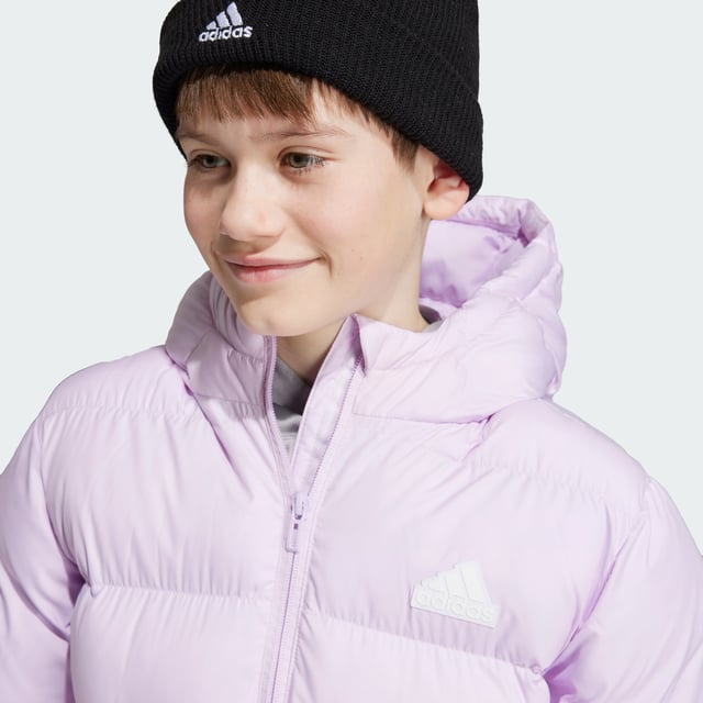 Made from sturdy ripstop and padded for warmth, this juniors' adidas jacket is your go-to during the colder months. Designed to keep the elements at bay without weighing you down, this long jacket offers plenty of coverage as you venture outdoors. A hood shields you from rain, while pockets keep your belongings tucked away. This product is made with 100% recycled materials. By reusing materials that have already been created, adidas help to reduce waste and our reliance on finite resources and reduce the footprint of the products adidas make.  - This model is 152 cm and wears a size 11-12Y. Their chest measures 70 cm and the waist 60 cm. - Regular fit - Full zip with hood - 100% polyester (recycled) - Front pockets - Self-fabric cuffs  Shipped by adidas