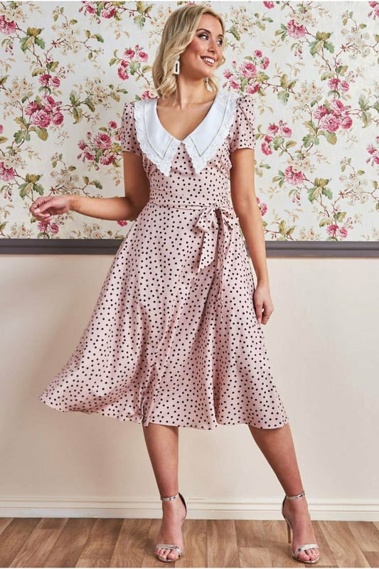 If you are looking for a cute little summer dress that is simple and stylish at the same time, then this polka dot tea dress with a collar from Goddiva is the one you want. The feminine cut accentuates your curves, while the short sleeves keep you cool on hot summer days! This classic polka dot day dress with a large collar is the perfect outfit for any summer day, from a picnic to that garden party you've been wanting to attend. This Tea Dress is designed with a high neckline, short sleeves and a fitted bodice, cinched at the waist with an eye-catching beige polka dots pattern. A style that will never not be fashionable and is an absolute essential to your summer wardrobe. This stunner of a short spring/summer dress is not only perfect for the obvious occasions, but is also a winner for date nights and of course the first thing you need to pack for your beach getaways. Team with sandals or wedges and let the dress do the talking.