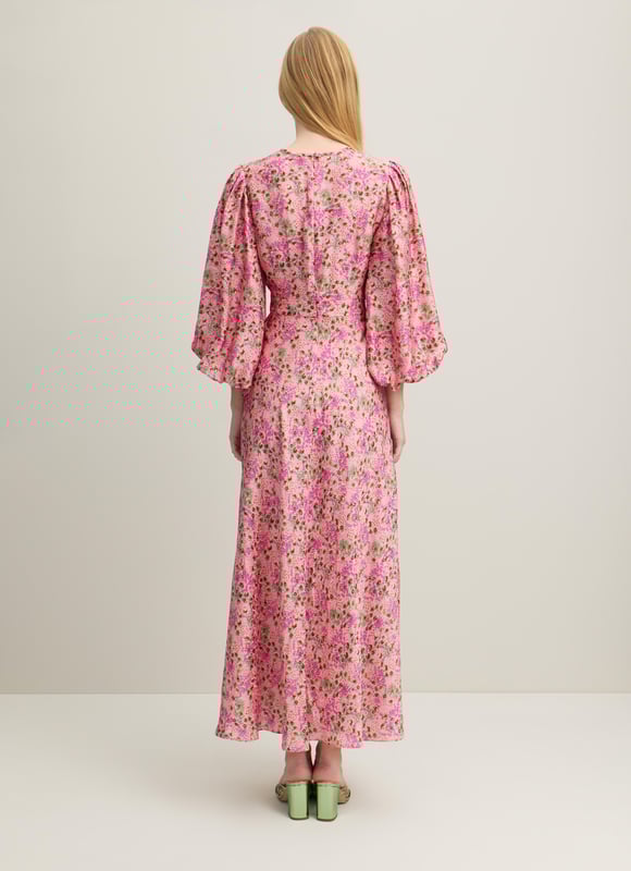 A beautiful new dress in our Royal Ascot collection, the Lois is pretty in pink with a reimagition of a French mid 19th century print. Crafted from a slinky viscose-silk blend in pink with a squiggle jacquard and a neon garden print, it has a round neck with pleating detail, puff shoulders, voluminous balloon sleeves and a long, floaty cut falling to a midi length. Wear it with heels and a hat to cheer on the winners.