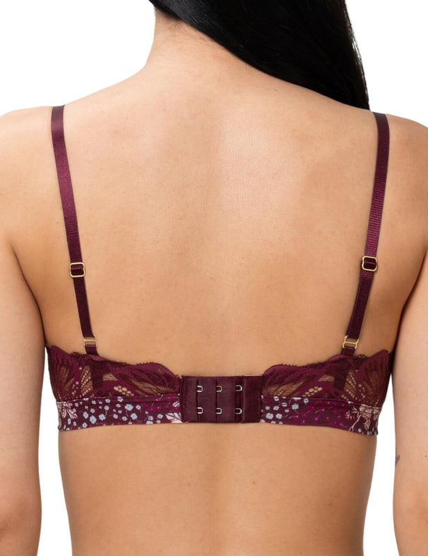 This stylish padded bralette comes from the Lavish Spotlight collection by Triumph. The padded cups offer comfort and support, whilst the tulle fabric drapes over each cup, joining to the band underneath the alternate cup creating a cross styling, with added fine line details along each mesh section. The band is decorated with a feminine floral print and offers a hook and eye closure. The mesh joins at the rear to complimentary detailed floral lace. The adjustable straps help for personalisation of fit and no underwiring is styled for optimal comfort.  Floral printed band, Complimentary lace at the rear, Adjustable straps, Hook and eye closure, Padded cups, Non-Wired, Fine detailed tulle mesh, Matching items available, Country of Origin: India, Composition: 46% Polyamide | 46% Polyester | 8% Elastane, Listed in UK sizes.   Bralette