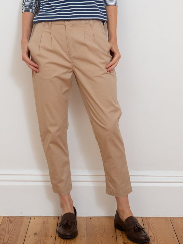 98% organic cotton 2% elastane | Beige | Twill fabric with a little bit of stretch | Apple enzyme washed for a soft hand feel | Zip and coconut button opening | Functional belt loops | Side pockets and back welt pockets | Cropped slim leg | Front pleating detail for a flattering fit | Made in Turkey | Machine washable at 40 degrees, or at 30 degrees to be kinder to the planet