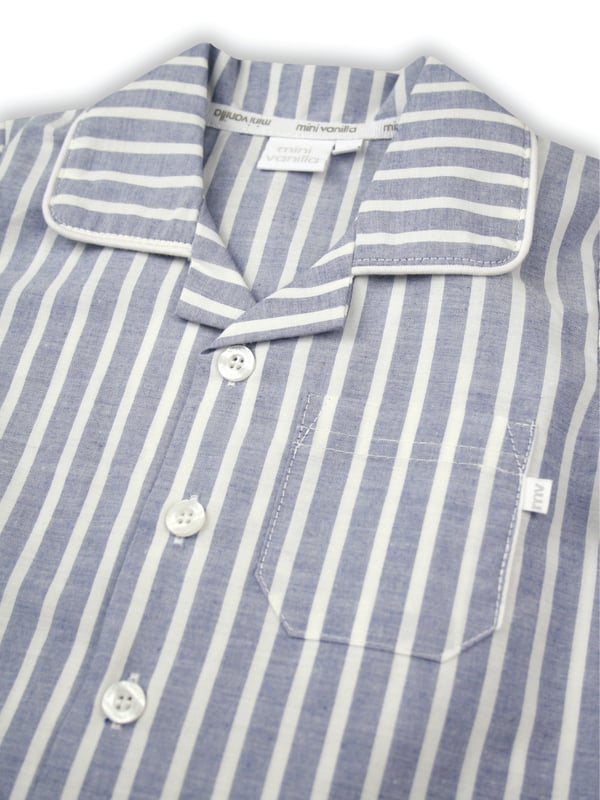 Blue and White Stripe Traditional Summer Pyjamas.

Our classic short sleeve crisp summer cotton boys pyjamas in a blue and white stripe creates a traditional look that’s perfect for lounging or sleeping. Made from super-soft 100% crisp cotton. The set is trimmed with white cotton piping. The top has an open collar and revere, single square pocket with MV tab and fastens with Mini Vanilla Engraved buttons. The crisp cotton comfy trousers have a fully soft elasticated waist and white piping at the hem to finish this very traditional boys pyjamas

Sold as a Pyjama set.
Fabric 100% cotton - crisp summer weight.
Fire Warning : KEEP AWAY FROM FIRE AND FLAMES.
Wash Care Instructions : Machine wash inside out, do not soak, wash dark                    colours separately, do not iron trims. Save energy and wash at 30 degrees.
Do not tumble dry