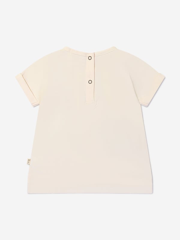 Introducing our Girls Organic Cotton Cherry Print T-Shirt from The Bonnie Mob in Pink, the perfect addition to your little girl's wardrobe. Made with love and care, this t-shirt is crafted from organic cotton, ensuring it is soft, comfortable, and gentle on her skin. Key Features: Made In Italy: This t-shirt is proudly made in Italy, guaranteeing the highest quality and attention to detail. Organic Cotton: We believe in sustainable fashion, which is why this t-shirt is made from organic cotton, reducing environmental impact. Cherry Print: The adorable cherry print adds a playful and cute touch to this t-shirt, perfect for your little girl. Flared Hem: Designed with a flared hem, this t-shirt offers a stylish and modern twist to a classic design. Long Waistband: The long waistband adds a touch of elegance and sophistication to this t-shirt. 'B' Motif: Featuring a golden 'B' motif, this t-shirt showcases The Bonnie Mob's signature logo, adding a touch of luxury to your little girl's outfit.Get ready to dress your little girl in style and comfort with our Girls Organic Cotton Cherry Print T-Shirt from The Bonnie Mob.