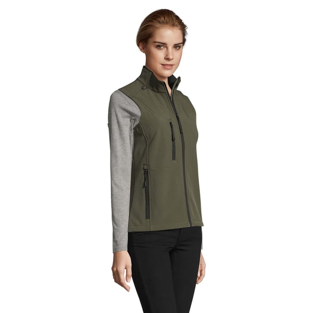 Stretch soft shell fabric has a polyester/elastane outer, membrane and a polyester fleece backing. Mesh lined front body panels. Breathable, windproof and water resistant. Shaped fit. Taped neck. Collar high full zip with inner storm flap and chin guard. Two front zip pockets and one right chest zip pocket. Adjustable drawcord at hem. Drop tail. Access for decoration. Material: 94% polyester/6% elastane. Ladies size: S(8/10), M(12), L(14), XL(16), XXL(18).