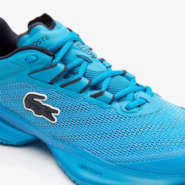 A new model this season  the AG-LT23 Ultra is designed to push tennis players’ abilities further than ever before with their lightweight and responsive design. From the Pebax technology that provides energy return  via the LSRFoam forefoot midsole  in combination with the enhanced stability offered from the TPU Plate Chassis and Heel Stabiliser  to the engineered breathable leno ‘Pique’ weave mesh upper for enhanced fit & breathability  they’re the innovative shoe every player needs to up their game. The outsole features Lacoste's brand new rubber compound; LineGrip. - Pro level performance Tennis shoe offering enhanced stability - Engineered breathable leno ‘Pique’ weave mesh upper for enhanced fit & breathability - Internal midfoot lockdown cage - Lacoste Super Responsive (LSR) Foam midsole in the Forefoot - High Performance EVA Foam in the Heel for enhances shock absorption - Full-length TPU plate chassis and heel stabilizer - 'LineGrip' Rubber Outsole - Ref: 745SFA001111C