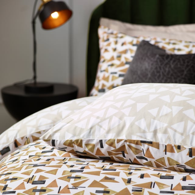 Inspired by modern, minimalist and abstract art, the City duvet cover set contains a fusion of small geometric shapes in warming tones, which combine to create this polished design. The reverse offers a muted, natural alternative for a more relaxing look. A sophisticated step into modern design for the contemporary home. This product is certified by OEKO-TEX® showing it has been sustainably made.
