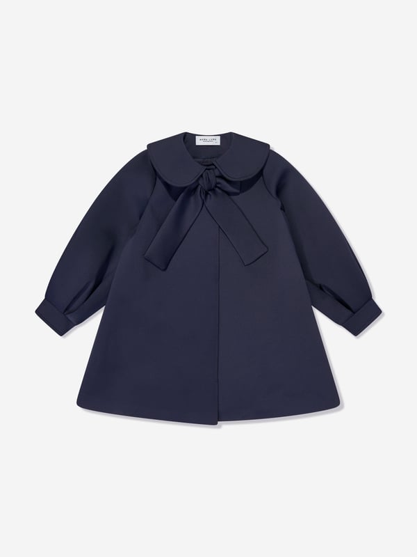 Mama Luma incorporate beautiful eco-friendly materials into their sophisticated handmade constructions. This girls navy long coat is reflective of the Californian label's precision of beauty. It showcases a Peter Pan collar, tie-up bow and balloon sleeves.  Cuffs Cotton Lining