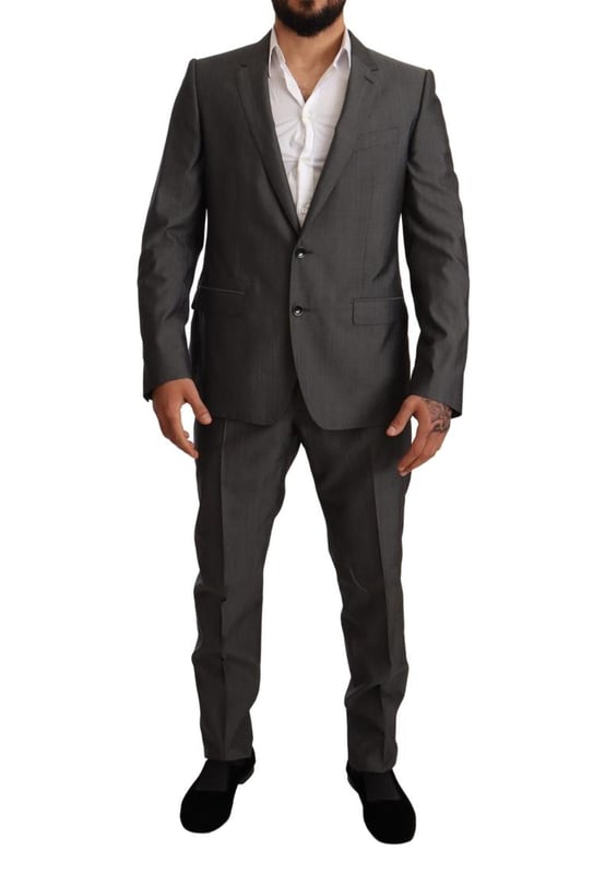 100% Authentic Dolce & Gabbana Suit
  Model: MARTINI
  Style: Single breasted 2 piece suit; includes blazer and pants
  Color: Gray metallic
  Closure: Two button closure
  Fitting: Slim fit
  Two inside pockets
  One open vent in the back
  3-way pants zipper closure
  Logo details
  Made in Italy
  Material: 65% Wool 35% Silk
  Lining: 100% Rayon