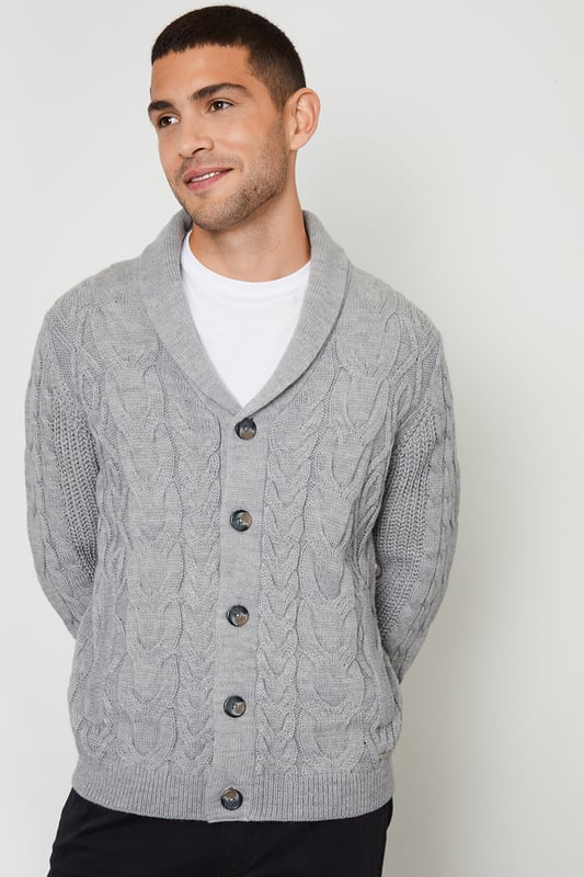 Upgrade your knitwear with this shawl collar knitted cardigan from Threadbare. With a stylish shawl collar and in a cable knit design, this jumper has ribbed cuffs and hem for comfort and full mock horn button fastening. Finished with two side welt pockets and the Threadbare metal branding tab on the hem. A great piece to have on hand for layering when the temperature drops. Pair with dark denim jeans and layer over a white tee for a stylish casual look.