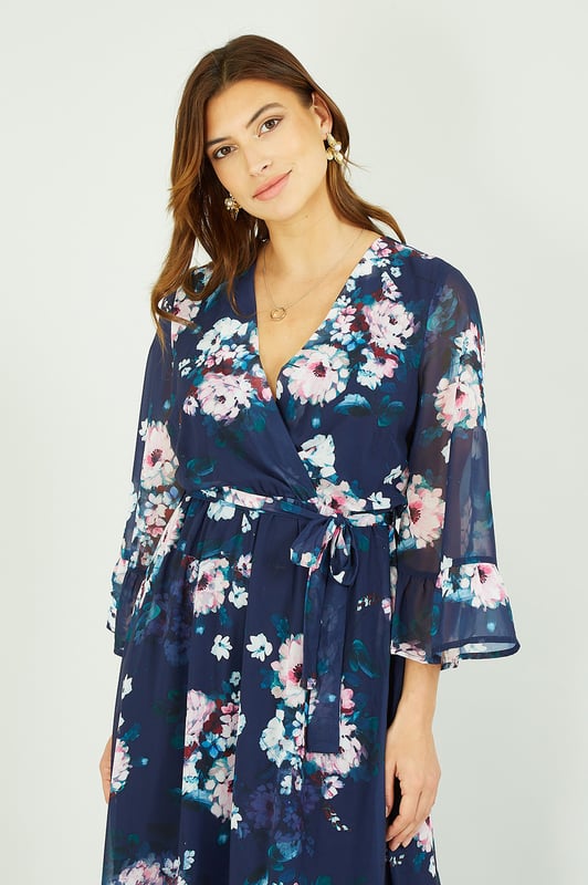 Featuring 3/4 cuffed sleeves, a flattering waist tie belt and a super cute dipped hem, this Yumi Navy Watercolour Floral Print Dress will inject a little pzaz into your closet. Wear for special occasions - just pair with strappy heels.