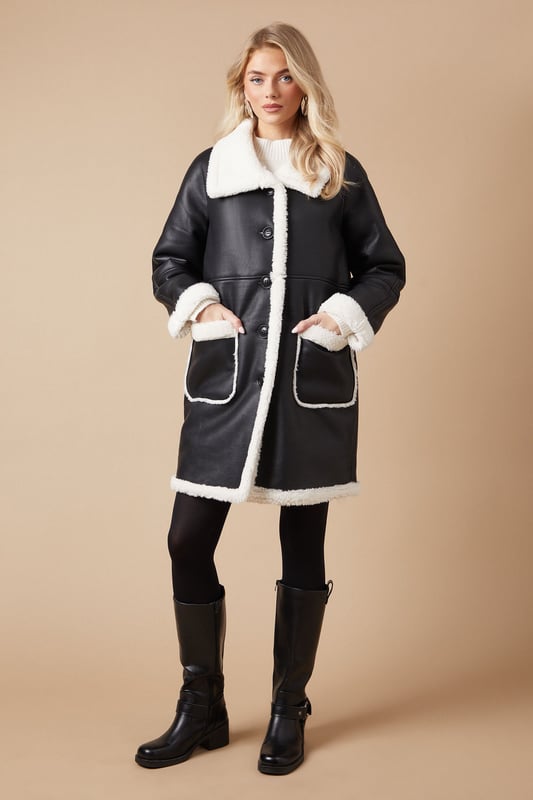 Luxurious shearling-style lining for ultimate warmth
        Oversized fit for effortless layering
        Contrasting patch pockets add a stylish touch
        Notched lapel collar for a classic look
        Long-line silhouette offers versatile styling options
    
    Embrace the chill with this striking bonded shearling coat from Oasis. The contrasting exterior and plush interior create a bold, eye-catching look that's perfect for making a statement on cooler days. Its relaxed fit allows for easy layering over your favourite jumpers and dresses, while the long-line silhouette provides ample coverage and warmth. Style it with slim-fit trousers and ankle boots for a chic daytime ensemble, or throw it over a floral midi dress for a pretty contrast at casual gatherings. The versatile design makes it an ideal choice for everything from weekend brunches to family outings. For a more polished look, cinch the waist with a statement belt to create definition and showcase your personal style.