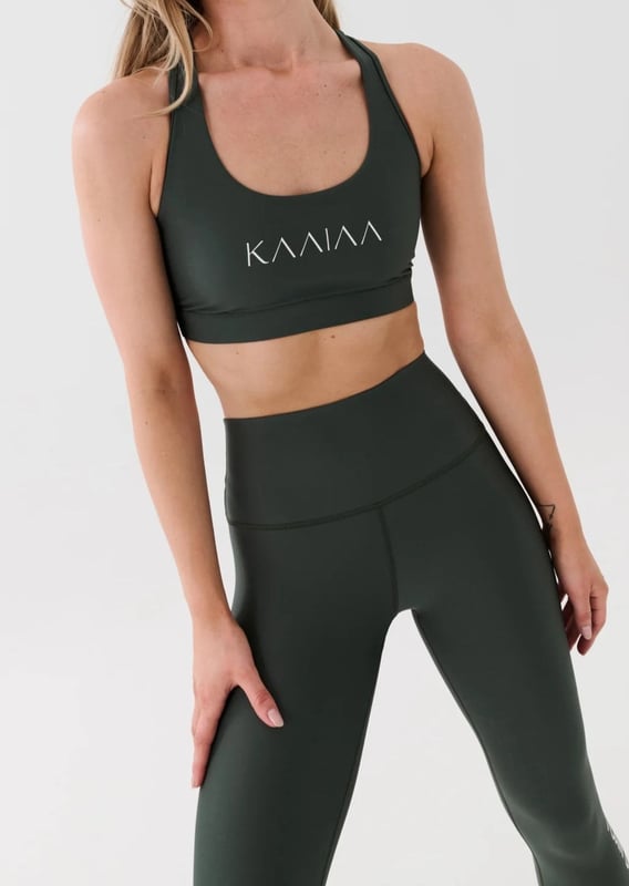 Scoop neck sports bra with a racer style back. Built in elasticated underbust support. KAAIAA logo print at front and back. P.E Nation logo print at back
