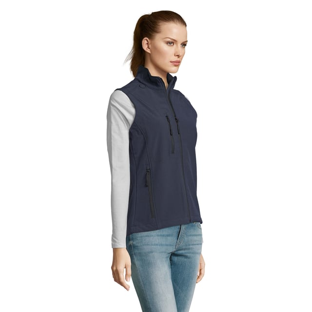 Stretch soft shell fabric has a polyester/elastane outer, membrane and a polyester fleece backing. Mesh lined front body panels. Breathable, windproof and water resistant. Shaped fit. Taped neck. Collar high full zip with inner storm flap and chin guard. Two front zip pockets and one right chest zip pocket. Adjustable drawcord at hem. Drop tail. Access for decoration. Material: 94% polyester/6% elastane. Ladies size: S(8/10), M(12), L(14), XL(16), XXL(18).
