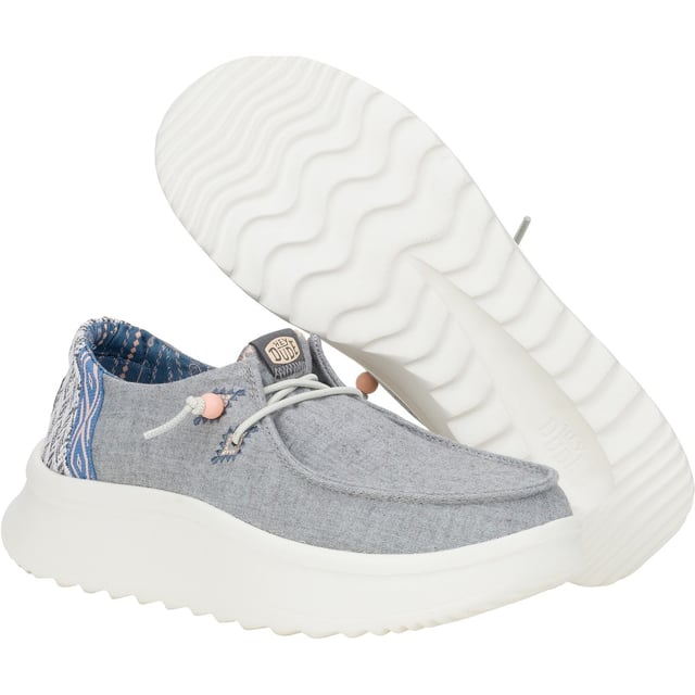 Up your style game with Wendy Peak Chambray Woven. Added, cushy comfort and height meets woven textile heel and webbing details for the perfect mix of comfort and style. So easy to put on you'll never wanna take 'em off.