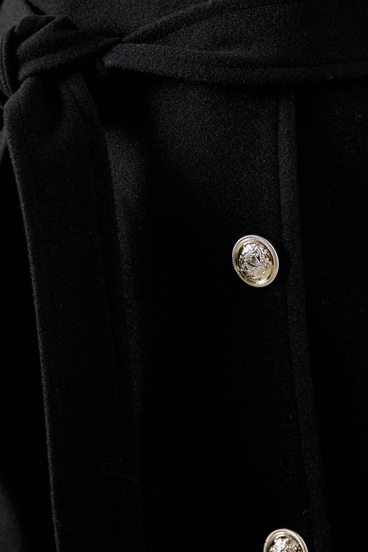 Elegant knitted collar for added sophistication
        Wrap design with button-through closure for versatile styling
        Long length offers maximum coverage and warmth
        Belted waist creates a flattering silhouette
        Functional side pockets for practicality
    
    This Wallis Knitted Collar Button Through Wrap Coat is the epitome of refined elegance. Perfect for the woman who appreciates sophistication without compromising on comfort, this coat is a versatile addition to any wardrobe. The wrap design allows for customisable fit, while the button-through closure adds a touch of classic charm. Style it over a sleek midi dress and pair with heeled boots for a polished look at formal events. For smart casual occasions, layer it over tailored trousers and a fine knit jumper, completing the ensemble with leather ankle boots. The long length and belted waist not only provide warmth but also create a striking silhouette that's sure to turn heads. Whether you're attending a business meeting or heading to a sophisticated dinner, this coat will ensure you look impeccably put-together while feeling effortlessly comfortable.
