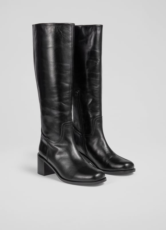 Imagine striding through cobblestone streets with an air of effortless elegance. The Claude knee boots, crafted from black Italian calf leather, feature a stylish block heel and a sophisticated rounded square toe. Perfectly versatile, pair them with tailored trousers for a smart look or with a flowing midi skirt for a casual charm.
