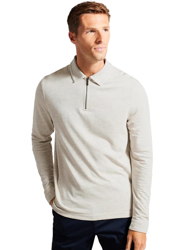 The Ted Baker men's Karpol long sleeve polo shirt in navy offers a refined take on a wardrobe staple. Crafted from a soft modal blend fabric, this polo delivers exceptional comfort and a luxurious feel against the skin. It features a classic collar and a zip placket, adding a modern twist to the timeless design. The long sleeves make it a versatile piece, suitable for both casual and smart-casual looks, providing style and ease for any occasion.