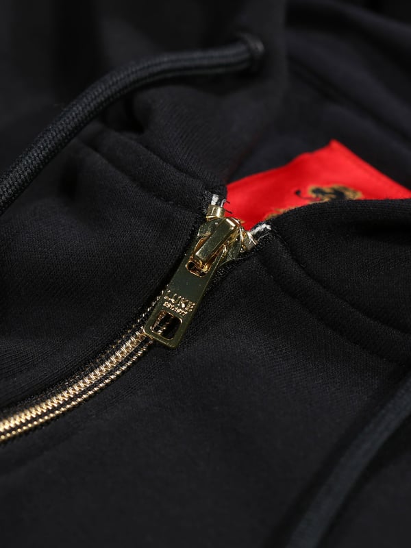 Comfortable, cool and classic, this hoodie from LUKE is cut from a cotton fleece back fabrication which ensures warmth and comfort in the colder months. It is detailed with a centre gold zip fastening running from hem to hood. The classics are considered and has soft rib cuffs and hem and is complete with the brands iconic lion head embroidery on the left chest. Iconic LUKE BLACK, GOLD, RED lion head embroidery. Iconic LUKE tri-colour trim tape. Matte black eyelets and cord ends. Centre front gold nylon zip. Side entry pockets. Ribbed cuff and hem.