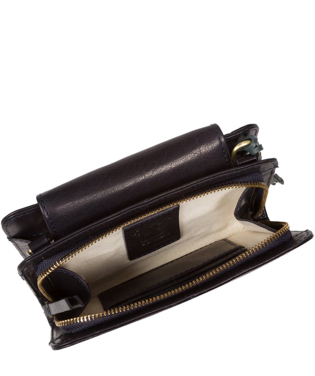 The 'Little Wonder' cross body clutch bag from Conkca London is handcrafted from multi-toned leather for a beautiful finish. A magnetic press-stud secured cover opens to reveal a compartment ideal for a smartphone. A zip-over top opens to reveal a second compartment that is perfect for your essential items and has three handy card slots. Lined with natural and untreated 100% cotton. It comes with an adjustable leather strap with a maximum drop length of 68cm, which is removable, converting the bag into a clutch bag. Adorned with the inimitable Conkca squirrel charm and Conkca logos.