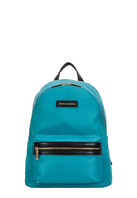 This backpack from the Ama collection use lightweight materials for a practical and stylish look. The functional shape is met with simple design features, like the signature gold logo debossed, along with flashes of gold hardware and leather trims. Inside reveals the branded lining and a spacious interior with a large slip pocket and smaller slip and zip pockets for valuable items. The Sand and Khaki version have a padded laptop pocket, ideal size for a 13 inch laptop. Features: , Nylon with leather trims, Smith & Canova gold debossed logo on leather badge, Zip round opening, Front zip pocket, Gold metal zip pulls, Gold metal hardware, Nylon and leather grab handle, Nylon and leather adjustable backpack straps, Smith and Canova branded lining, Internal slip pocket, Inner slip and zip pockets