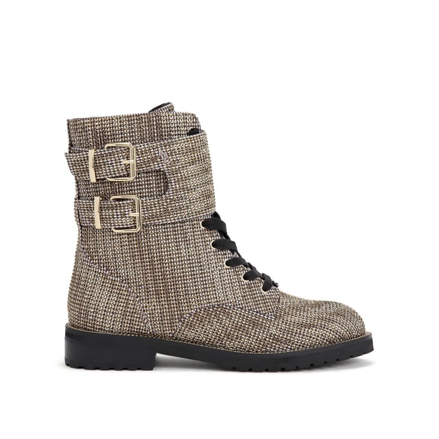 The Sutton ankle boot arrives in a beige houndstooth fabric topped with gold crystal embellishment. The front is laced up with two gold tone buckled ankle straps. Heel height: 3cm.