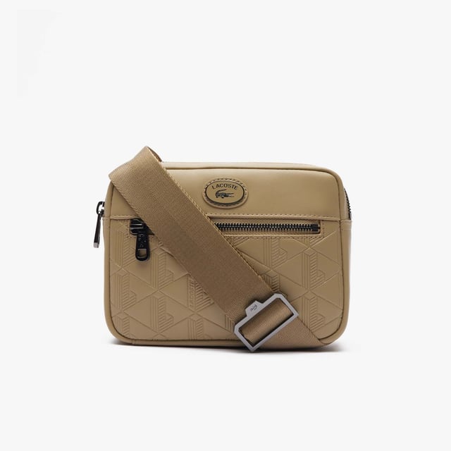 Leather Monogram Print Vertical Satchel.- Dimensions: L5.9 x H8.3 x D2 in.- L15 x H21 x D5 cm.- Exterior in split calfskin leather.- Adjustable strap: 75cm - 140cm - 29.5 - 55 in.- 1 zipped pocket on outside, 1 mesh patch pocket on inside.- Enamel plaque with crocodile logo. Material: 100% Polyurethane. Ref: NH4486MRC87.