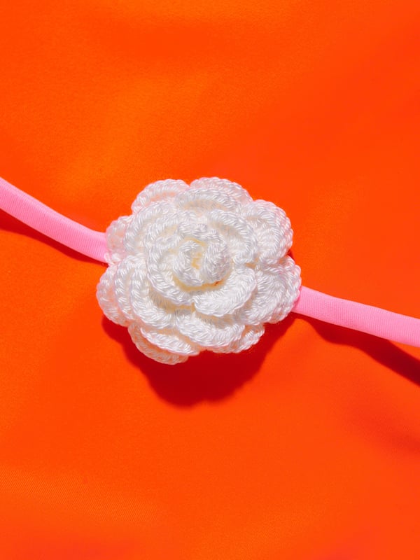 Nessi Byrd incorporate captivating materials into their everyday luxury swimwear. This girls Pina orange and pink swimsuit is reflective of the New York label's meticulous attention and preference for vibrant aesthetics. The top is depicted with a ruffled top and a bordered belt with a crochet flower accessory. Elasticated 80% Polyamide 20% Elastane