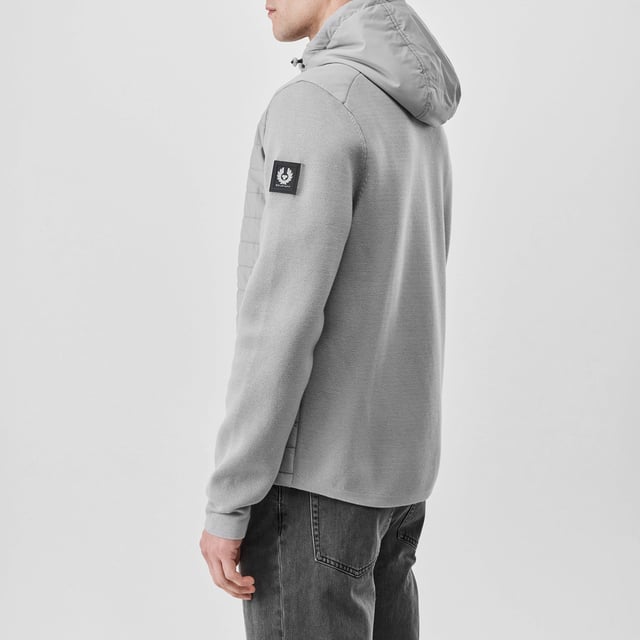 Mens Belstaff Pima Cotton Vert Full Zip Cardigan in grey.- Adjustable drawcord hood.- Two-way centre front zip fastening with drawcord detail.- Two side zip pockets.- Embroidered edge Phoenix patch on sleeve.- Padded body and cotton sleeve.- 100% Polyester.- Ref: 104626CRGRY