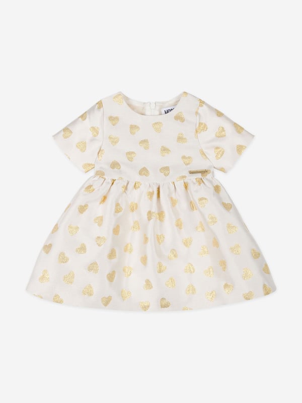 Italian fashion House Moschino depict energy and precision into their fun-filled abstracts. This baby girls dress  encapsulates unparalleled energy and sophistication. Engineered in gold lurex thread via a flared skirt and jacquard hearts embroidery all over. She will be obsessed.  ‚ Crew Neck‚ Short Sleeves‚ Back Zip Closure‚ 7% Metal, 20% Polyamide, 73% Polyester‚ Lining: 100% Cupro
