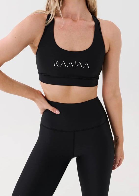 Scoop neck sports bra with a racer style back. Built in elasticated underbust support. KAAIAA logo print at front and back. P.E Nation logo print at back