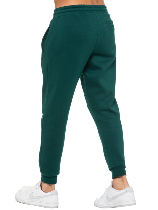 Enzo Mens Regular Fit Joggers. Elasticated Waistband With Adjustable Drawstring. Features 2 Side Slash Pockets & Single Welt Back Pocket. Cuffed Ankle. Features EZ Logo.