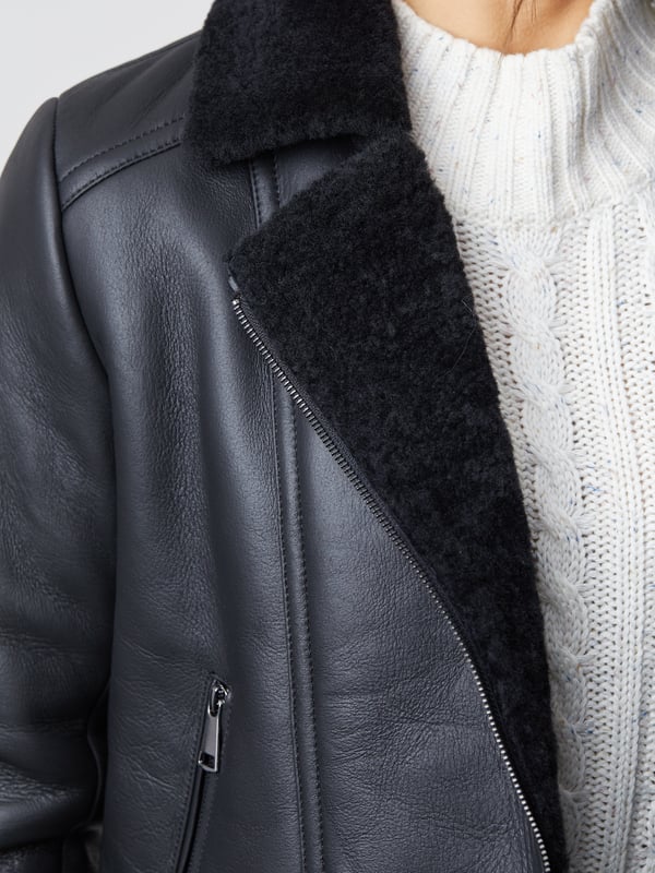 Lindeth Sheepskin Aviator Jacket in Black Our new-in flattering Lindeth aviator jacket is crafted in rich sheepskin with a smooth external nappalan finish. The black colourway is elegant and timeless and you can pair this jacket easily with your favourite knits to stay cosy all winter long.Featuring an asymmetric zip front inspired by biker jackets, the snuggly lapel collar and cuffs will keep you warm and cosy when the chilly weather comes around. Plus you can keep your hands extra warm with two handy front zip pockets.Sheepskin is nature's finest insulator and temperature regulator, meaning you will stay unbelievably warm and comfortable without overheating. The Lindeth jacket truly is the perfect investment for years to come.Sizing InformationThese measurements are based on a size 12 and will vary slightly between sizes.Approximate centre back length: 61cmApproximate sleeve length from shoulder to cuff: 62cm Approximate sleeve length from underarm to cuff: 45cmThe DetailsStyle Name: Lindeth Sheepskin Aviator JacketColour: BlackMaterial: 100% sheepskin with a nappalan finishFit: True fitAsymmetric front zip fasteningSheepskin lapel collarTwo front zip pocketsSheepskin cuffsAnd on the inside100% sheepskin