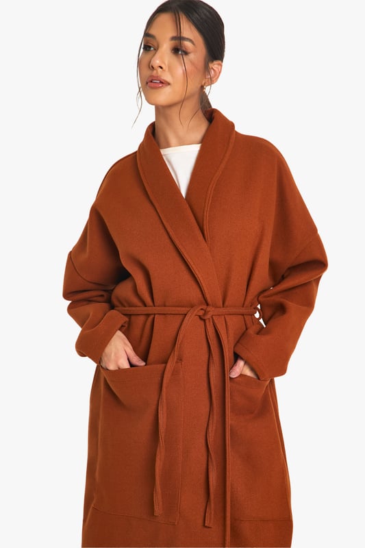 Wrap up warm in the latest wool look coats. A stylish way to cover up from the colder weather, wool coats work on off-duty days as well as those nights out with the girls. A warm and durable classic that mimics a sheep's wool blend and is perfect for winter, try slouchy silhouettes, military styles or checked prints. Everyone is loving wool look coats for autumn and so are we! Why not go for a black wool coat or opt for the trending wool trench coats to team with a long sleeve top and jeans for a go-to daytime look? For that extra elevated finish, pick a wool look jacket with a faux fur collar or tailored fit to really up your style game.Style: Wool Look JacketFabric: PolyesterSleeve Length: Long Sleeve