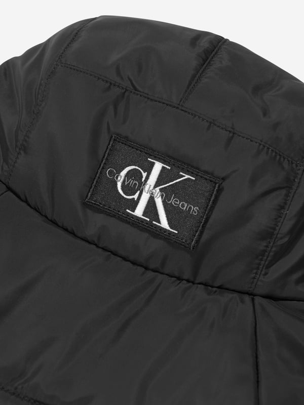 Introducing the Kids Quilted Bucket Hat in Black by Calvin Klein Jeans‚ the perfect accessory for your unisex wardrobe this Summer. Here are the key features of this exquisite piece:‚Classic Design: Made to shield your little ones from the sun with style, its quilted design offers a chic and modern look.‚ Premium Quality: Sourced with top-notch materials, ensuring uncompromised comfort and durability for your child's everyday use.‚ Versatile: Adapts perfectly with any outfit‚be it at the beach or during a casual city-walk. A Black bucket hat never goes out of style!‚ Signature Brand: Designed by Calvin Klein Jeans, this bucket hat epitomizes premium fashion in every stitch. Don't wait! Let your child flaunt the timeless style of Calvin Klein with our Kids Quilted Bucket Hat in Black.