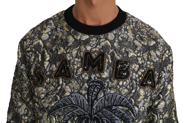 Dolce \u0026 Gabbana Jacquard Palm Tree Crewneck-tröja\n  100% äkta och helt ny med taggar\n  Pullover med crewneck-design\n  Flerfärgad palett med nyanser av grått och guld\n  SAMBA Jacquard Palm Tree-motiv\n  Logotypdetaljer\n  Tillverkad i Italien\n  Hantverk av hög kvalitet\n  Materialets sammansättning: 54% Polyester 17% Silke 17% Nylon 12% Metallfiber\n  Finns i märkesstorlek IT46 / US36 (passar storlek S)\n  Perfekt komplement till alla garderober\nMaterial: 54% Polyester 17% Silke 17% Nylon 12% Metallfiber
