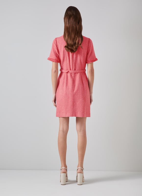 LK Bennett Allie Dresses, Blush The little tweed dress is a wardrobe classic, it will never fall out of style. Our new Allie dress is crafted in Europe from dark pink Italian tweed using recycled cotton, and is a short shift with a round neck, a raw edge trim, short sleeves, single-breasted hammered gold buttons, a fabric buckle belt and patch pockets on the skirt. Super chic and simple, wear it with stylish flat or a fun pair of platforms.