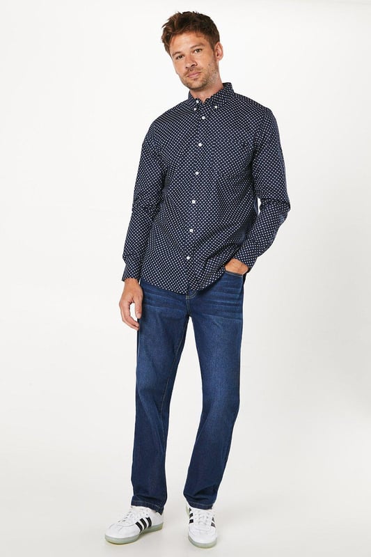 Striking geometric print for a modern twist on classic shirting
        Button-down collar for a smart-casual look
        Long sleeves with adjustable cuffs for versatile styling
        Chest pocket adds a functional touch
        Regular fit allows for comfortable movement
    
    This Maine geo print long sleeve shirt is a versatile addition to any wardrobe, perfect for those seeking a balance between style and comfort. The eye-catching geometric pattern adds interest to your ensemble without overwhelming it, making it suitable for various casual occasions. Pair it with your favourite jeans and trainers for a relaxed weekend look, or dress it up with chinos and loafers for a smart-casual dinner out. The cotton fabric ensures breathability and ease of care, ideal for the busy modern man. Layer it under a jumper on cooler days or wear it open over a plain t-shirt when the weather warms up. Whether you're heading to a family gathering, meeting friends at the pub, or enjoying a casual day at the office, this shirt will keep you looking effortlessly stylish.
