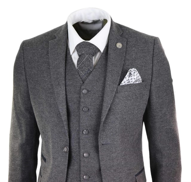 A grey suit is a key staple in every mans wardrobe and this one is no exception to this unwritten rule. Sharp, sleek and sophisticated, look the part with this premium 3 piece grey wool tweed suit, that features a slim fit cut, with a closer fit across the chest and narrower tailored trousers. the two-button jacket hangs beautifully and has a half canvas construction that moulds to your body shape the more you wear it. Contrasting velvet pocket piping, buttoned cuffs and a single back vent lend the suit a classic touch of refinement. A matching tweed waistcoat completes the 3-piece with a single breasted down style with classic tailored pockets and a back adjuster to ensure you can create your ideal fit. The suit is evergreen and contemporary at the same time and allowing you to look the best all day. Pair it with a matching waistcoat, a white shirt and shoes for a dapper finish.