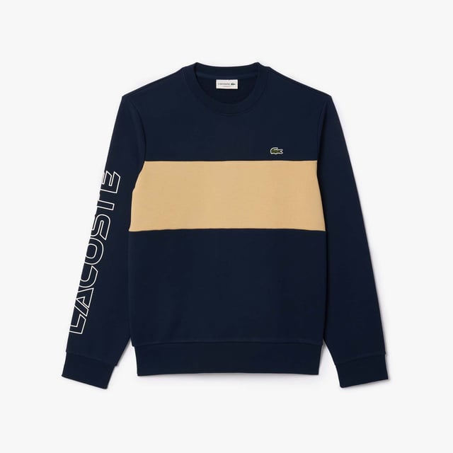 Color combination and graphics for a Lacoste dynamic and creative identity. Classic fit  natural ease on body with comfortable sleeves Our classic French terry Cut & sewn colorblock crew neck sweatshirt in mix of two different colors Rib at sleeves and bottom of body 3cm green crocodile at chest Lacoste wording 3D print at right sleeve.