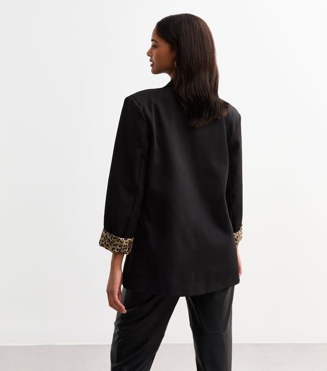 Elevate your style with our sleek Black Contrast Animal Edge to Edge Blazer. Stand out with its unique animal print contrast, perfect for the fashion-forward woman. This versatile blazer can be dressed up or down, making it a stylish addition to any wardrobe.
